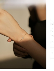 Detailed view of an S925 sterling silver gold bracelet with a hollow pave circle pendant