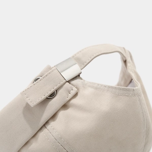Detail of adjustable metal strap buckle on beige cotton twill minimalist docker hat