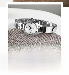 Macro detail of elegant silver bangle quartz watch with white dial and roman numerals