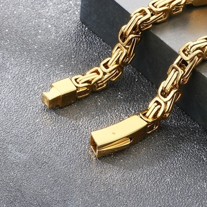 Detail of gold Byzantine style thick stainless steel chain bracelet with buckle clasp