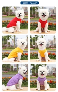 Three colorful cotton pet vests in red, yellow and purple for small dogs on outdoor grass