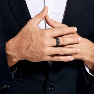 8mm men's matte black stainless steel ring with triple grooves worn by a model in suit