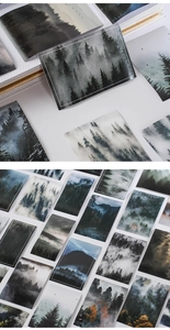 Macro detail of dark green forest stickers showcasing paper texture and aesthetic landscapes