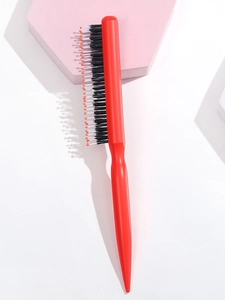 Detail of red pointed tail teasing comb with protective orange ball-tipped bristles