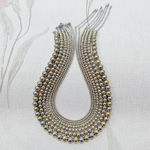 Detail view of multi-layered gold and silver stainless steel beaded necklaces with lobster clasp
