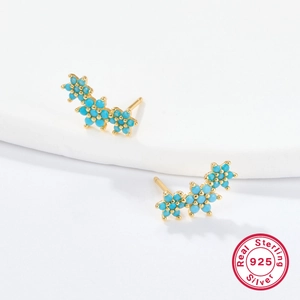 Detailed view of S925 sterling silver flower stud earrings with blue zircon in gold finish