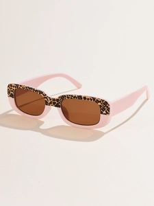 Detail of pink resin sunglasses frame featuring vintage leopard print and brown lenses