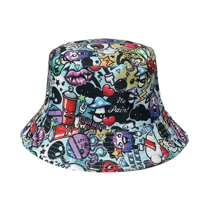 Detail of vibrant graffiti bucket hat featuring colorful monster prints and urban text