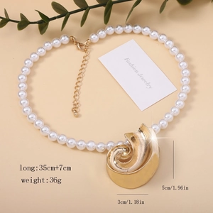 Detail view of starfish seashell necklace with white pearls and gold shell pendant