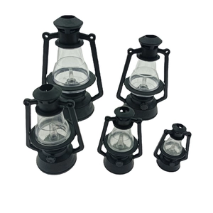 Set of five various sized miniature black vintage lanterns with clear shades on white background