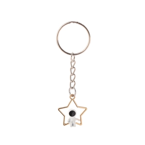 Detailed close-up of a hollow star keychain with a small astronaut figure inside
