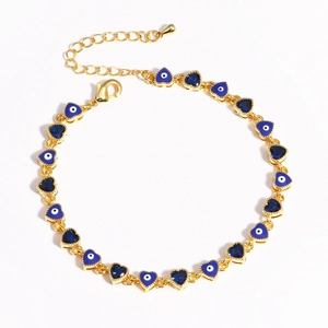 Close-up of gold evil eye heart charms and blue crystal links on jewelry chain