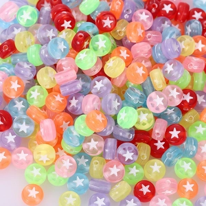 Macro detail of multi-colored acrylic beads with white star patterns for DIY jewelry making