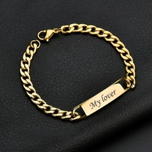Detail of gold stainless steel Cuban chain bracelet with My lover engraving on nameplate