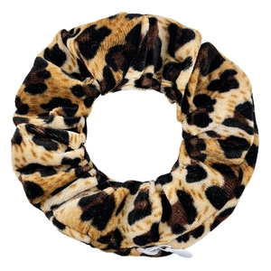 Detail of leopard print velvet scrunchie with a hidden zipper pocket for storage