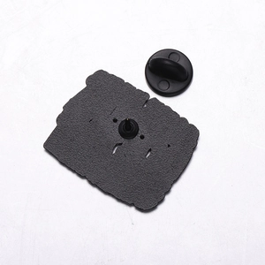 Detail view of the metal pin back with textured base and black rubber clutch closure