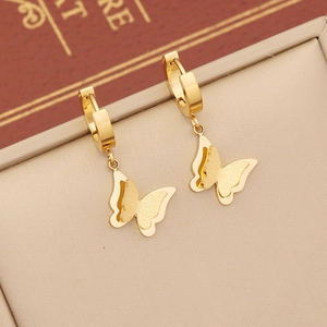 Elegant gold butterfly earrings with polished and frosted textures in a jewelry box