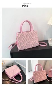 Pink fashion bag with fringe texture detail and round top handle for styling