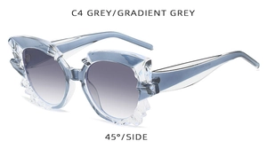 Close-up of irregular jagged crystal edge on grey gradient fashion sunglasses