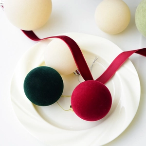 Velvet flocked Christmas ball ornaments in red, green, and white with hanging strings