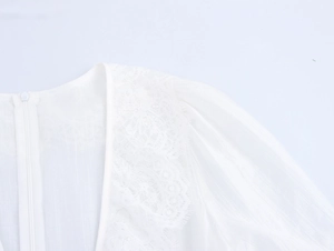 Détails de dentelle blanche et fermeture éclair invisible sur le côté de la robe