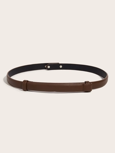 Close-up of slim dark brown leather belt with adjustable loop and smooth texture