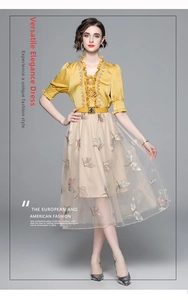 Detail of a French-style two-piece dress with yellow silk bodice and floral buttons