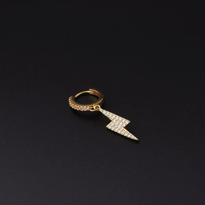 Detailed view of a gold lightning bolt drop earring with pavé-set shimmering stones