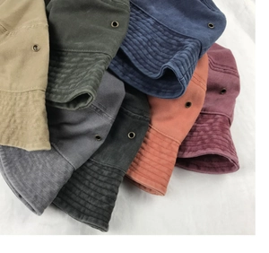 Stack of multi-color washed cotton fisherman hats with side metal ventilation eyelets