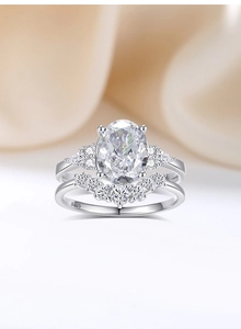 Detail of 2.5ct oval cut sparkle diamond ring set in 925 silver on champagne silk fabric