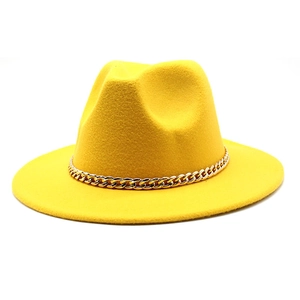 Close-up of bright yellow wool fedora hat featuring a chunky gold metal chain detail