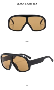 Detail view of oversized retro sunglasses in black frame with light tea lenses