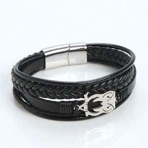Detail of multi-layer leather bracelet with silver owl charm and magnetic clasp