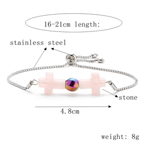 Detail of adjustable stainless steel cross bracelet with pink natural stone and specs