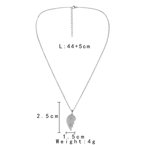 Detail of silver stainless steel heart pendant with pinky promise engraving for couples