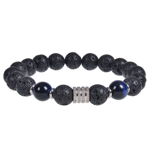 Macro shot of 10mm black volcanic beads and blue tiger eye stone bracelet with silver charm