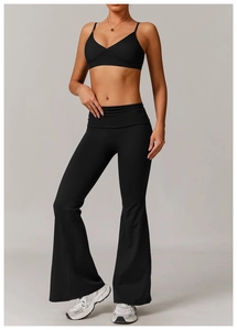 Detail of black V-neck sports bra and high-waisted flared yoga pants on model