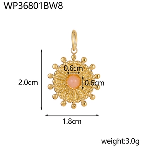 Macro detail of sunflower pendant with pink stone and dimensions of 2.0cm x 1.8cm