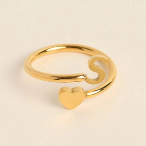Detail of adjustable gold bypass ring featuring a 3D heart and the letter S design
