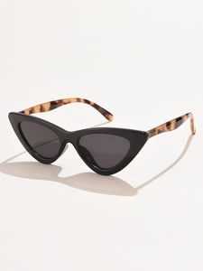Detail showing thick black cat-eye frame and tortoise shell patterned temples of the sunglasses