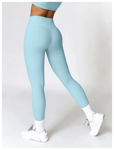 Close-up of light blue high-waisted yoga leggings showing peach lift effect and seamless fit