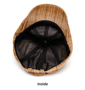 Detail of the brown striped newsboy cap featuring black hexagonal lining and elastic back