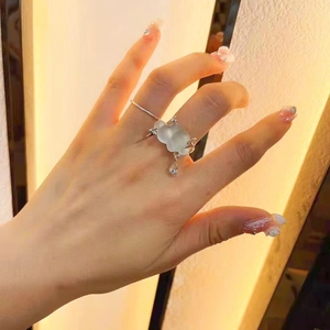 Minimalist silver cloud ring with translucent water drop pendant on hand