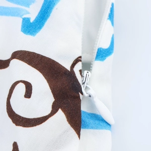 Detailed macro view of white invisible zipper and stitching on floral printed fabric