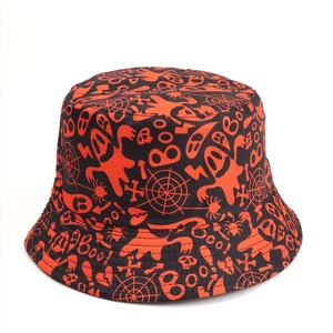 Detail of Halloween bucket hat with orange ghost and spider web prints on black fabric