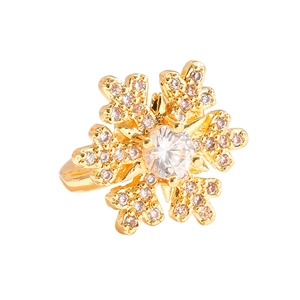 Macro view of a gold snowflake ring with central zircon and pavé detailing