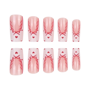 Pink French press-on nails with sweet red bows and heart patterns for a ballet style