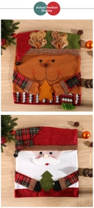 Detail of Christmas chair covers featuring Santa and reindeer with red plaid fabric