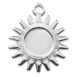 Macro detail of silver sun pendant with radial rays and blank center for DIY jewelry