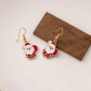 Christmas Santa Claus drop earrings in red and gold on a minimalist wooden stand